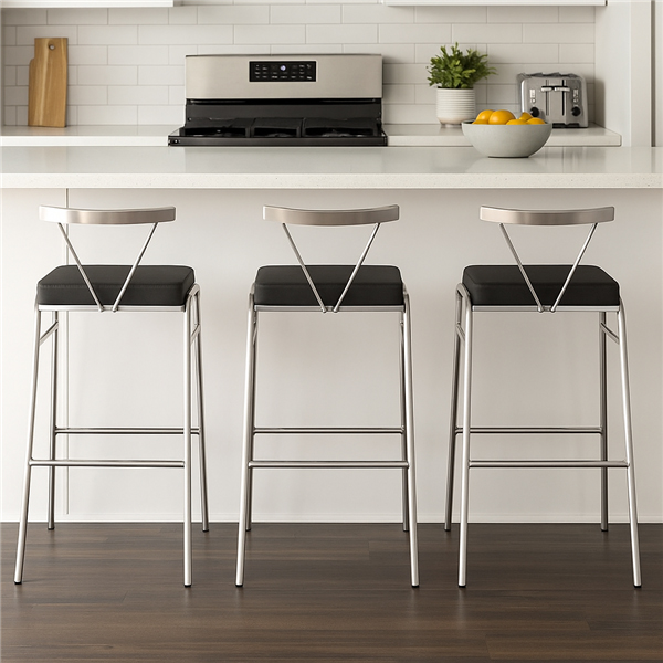 Three stainless steel kitchen bar chairs with black seats lined up at a white kitchen island