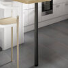 80mm matt black bar leg installed beneath wooden counter in modern kitchen setting