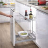 hand pulling out 2 tier cabinet organiser with chrome baskets in modern kitchen