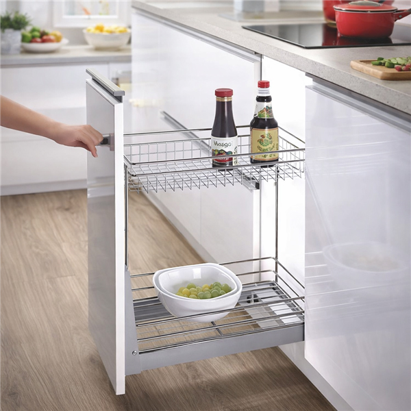 hand pulling out 2 tier cabinet organiser with chrome baskets in modern kitchen