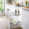 pull out cabinet organiser with two chrome baskets storing bottles and kitchen items