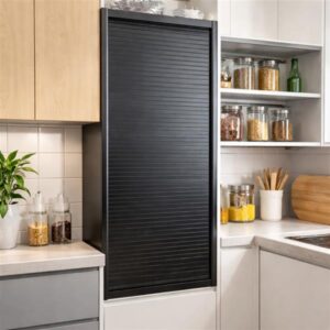 Black plastic roller shutter installed in modern kitchen cupboard with concealed storage