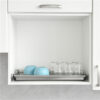 Cupboard dish rack with pull out drip tray inside cabinet