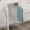 3 arm chrome pull out towel rack installed inside kitchen cabinet with towels hanging
