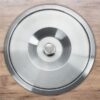 Stainless steel counter bin lid installed flush into a wooden kitchen countertop