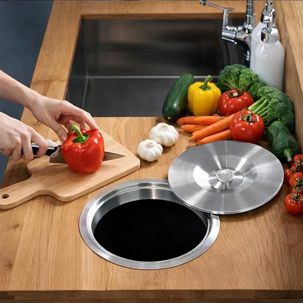 Stainless steel counter bin lid installed in kitchen countertop for easy food prep waste disposal