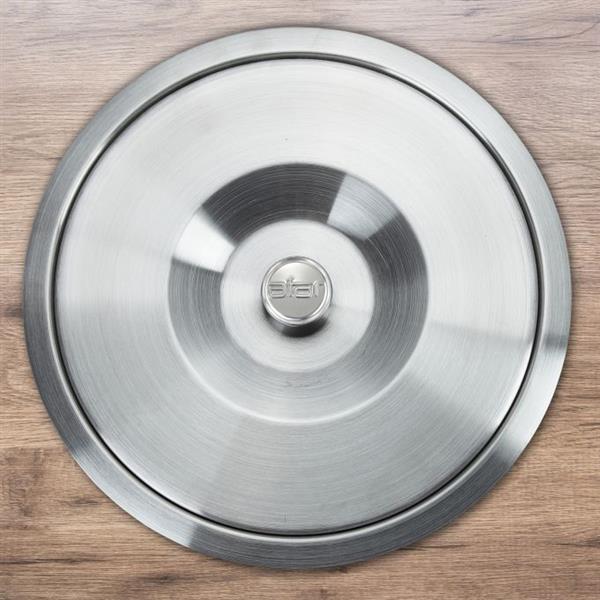 Stainless steel counter bin lid installed flush into a wooden kitchen countertop