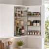 Top Cupboard Tandem Pull-Out with six chrome baskets storing spices and pantry items